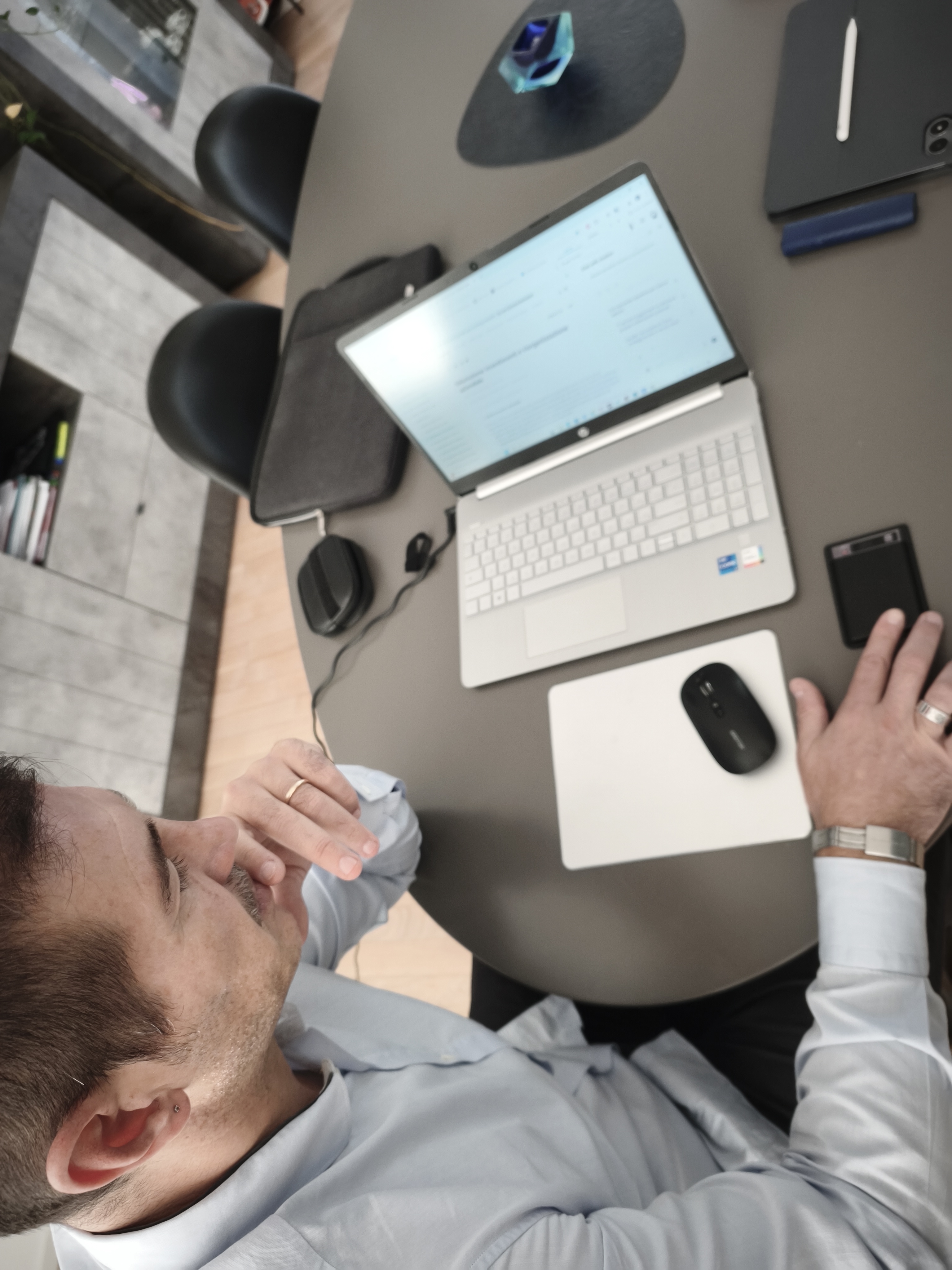 Alfredo Cruciani working at a laptop at his desk, focused and in thought