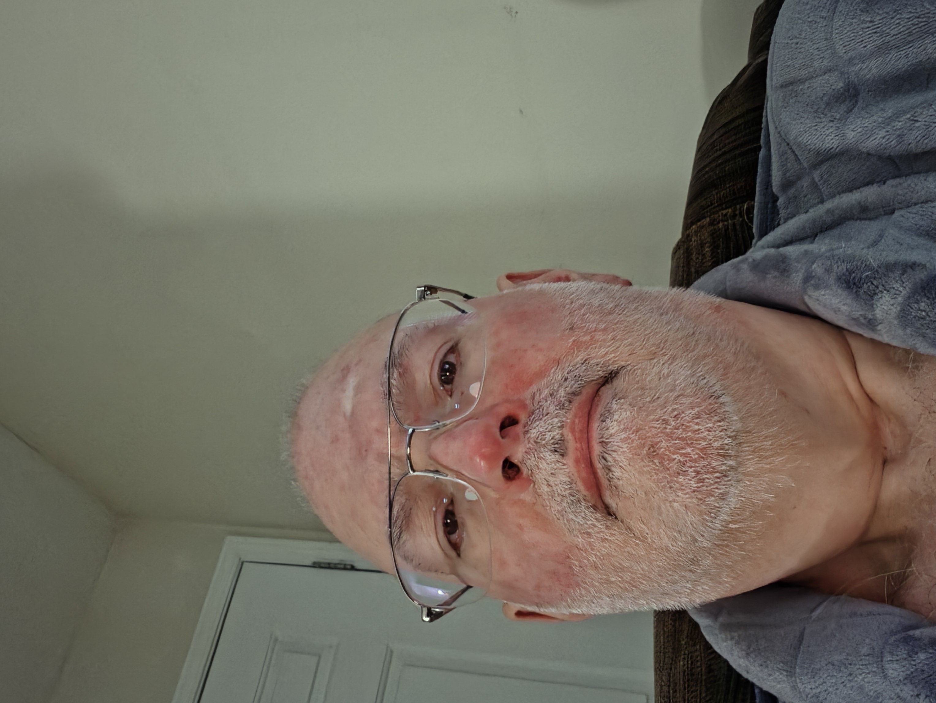 William Groom, telecom system administrator, casual home portrait with glasses